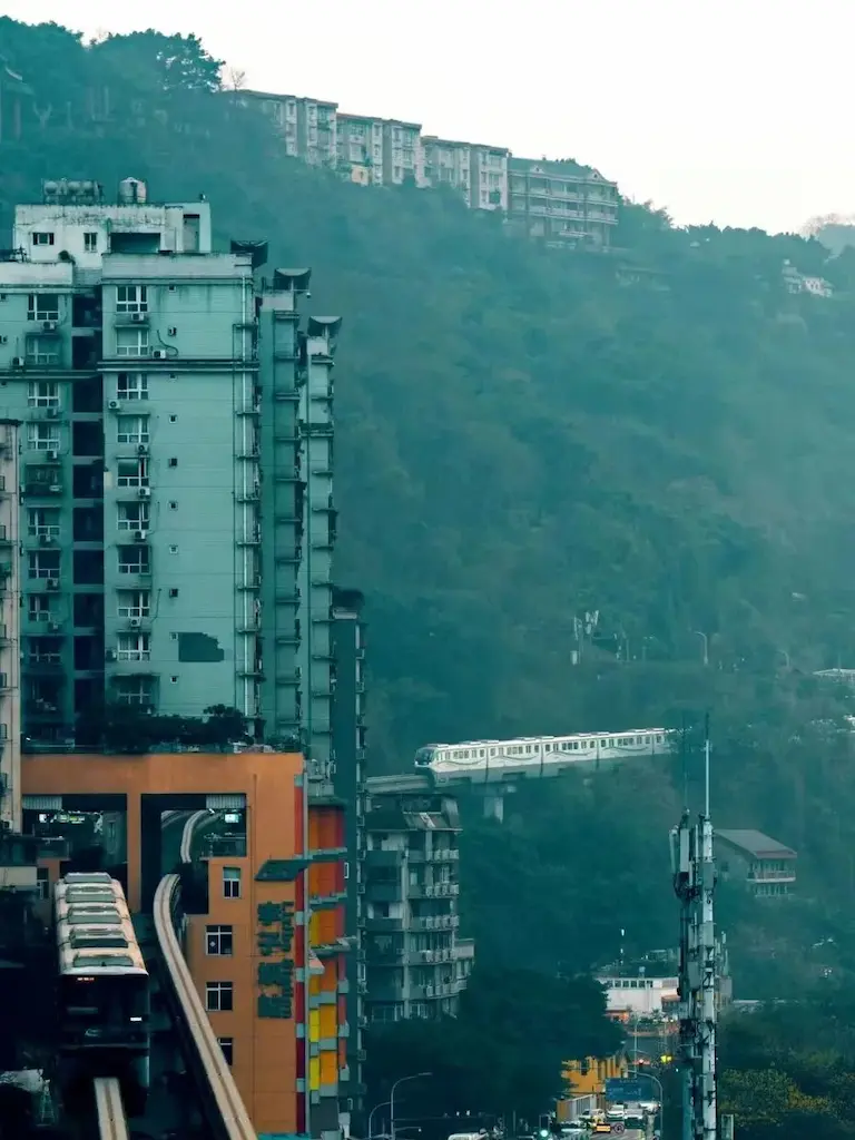 Watching the light rail pass through a building in Liziba, Chongqing