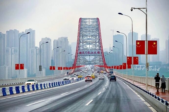 Chaotianmen Yangtze River Bridge with traffic and Chinese flags