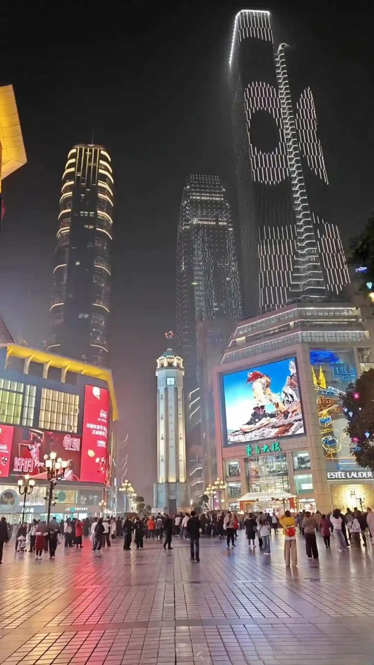 Chongqing's Liberation Square at night, crowds and skyscrapers
